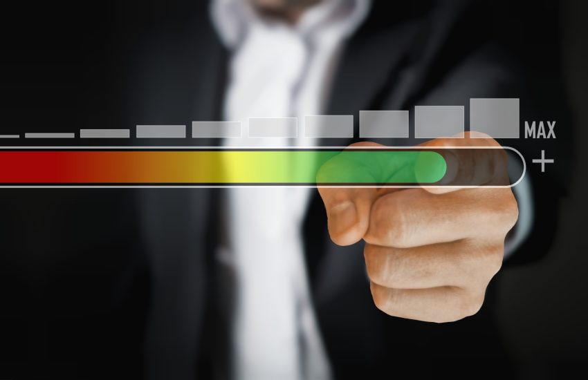 Hand pointing at a growth meter and chart.